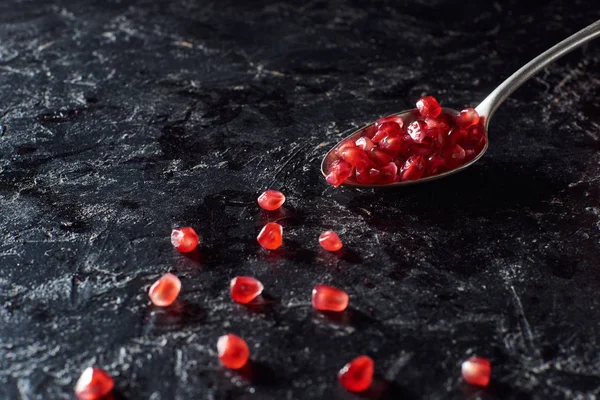 Studio Shot Spoon Garnet Seeds Black Surface — Stock Photo, Image