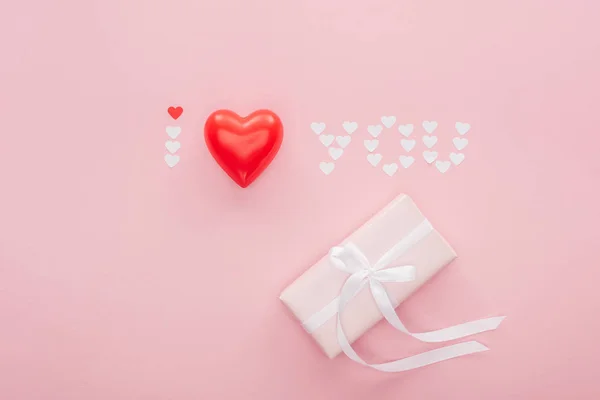 Top view of gift box and 'i love you' lettering made of paper hearts isolated on pink, st valentines day concept — Stock Image Top View Gift Box Love You Lettering Made Paper Hearts Royalty Free Stock Images