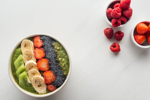 top view of smoothie bowl with fresh fruits on white background