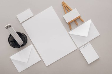 flat lay with blank cards and stationery on grey background clipart