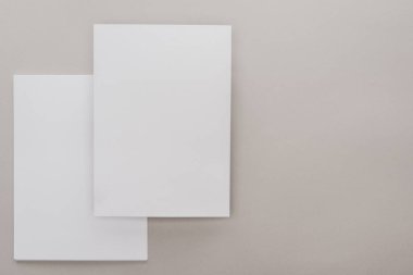 top view of white empty papers on grey background clipart