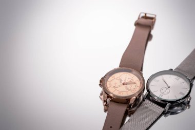 elegant swiss wristwatches lying on grey background clipart