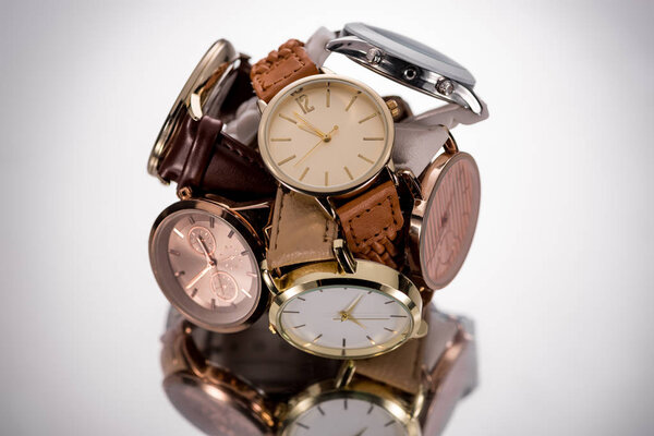 selective focus of swiss wristwatches on grey background