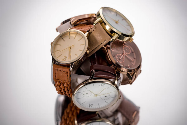 selective focus of elegant wristwatches on grey background