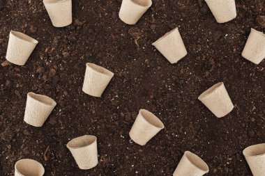 top view of used paper cups on ground,  protecting nature concept  clipart
