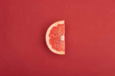 top view of half slice of fresh ripe juicy grapefruit red background clipart