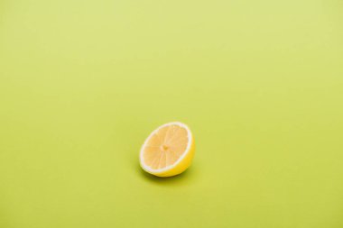 Half of fresh juicy lemon on green background clipart