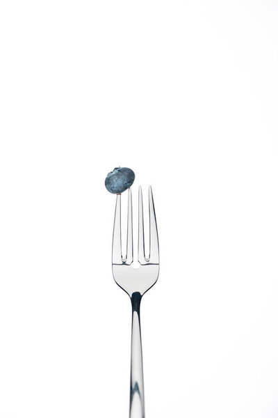 whole fresh ripe blueberry on fork isolated on white