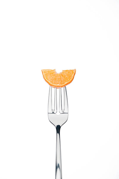 slice of fresh ripe juicy tangerine on fork isolated on white