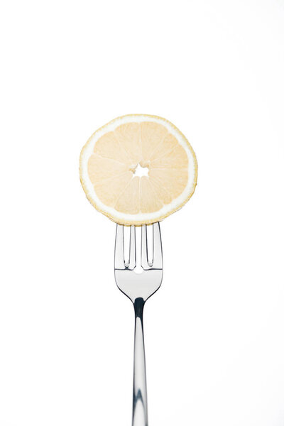 sircle slice of fresh ripe juicy lemon on fork isolated on white