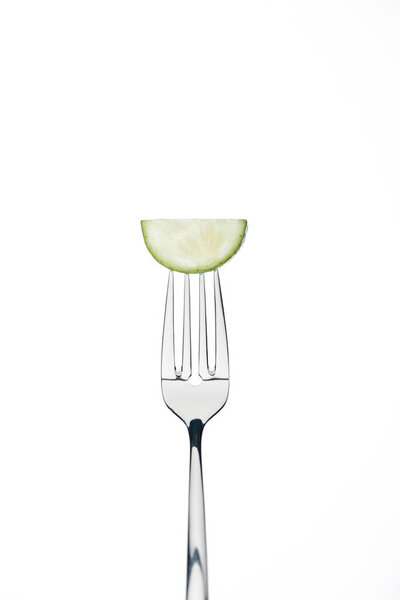 half slice of fresh ripe cucumber on fork isolated on white