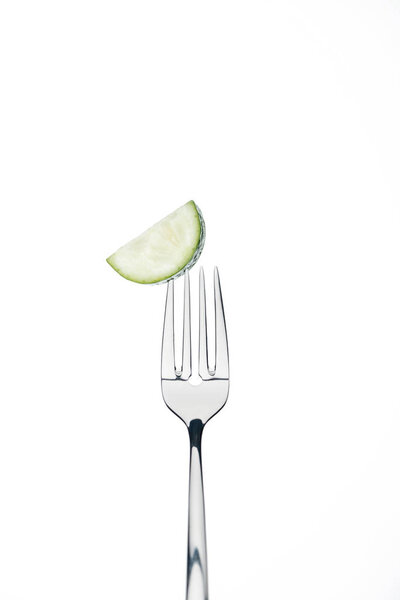 half slice of fresh ripe cucumber on fork isolated on white