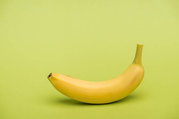 top view of fresh ripe banana on light green background