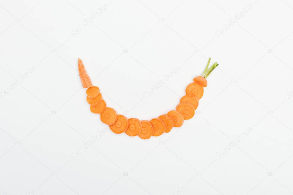 top view of ripe raw carrot slices arranged in arc line isolated on white