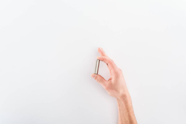 Cropped view of man holding battery on grey background