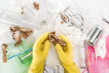 Can, cam şişeler, plastik torbalar arasında kağıt tutan adam görünümünü kırpılmış, kağıt şeritler ve Plastik tüpler