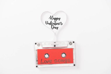 top view of audio cassette with 'love songs' lettering and heart symbol isolated on white with 