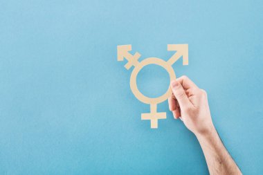 cropped view of male hand with white paper cut gender sign on blue background, lgbt concept clipart