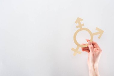 partial view of female hand with paper cut gender sign on grey background, lgbt concept clipart