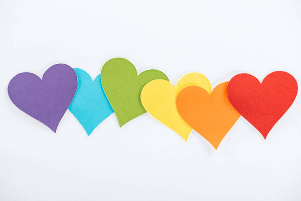 rainbow colored paper hearts on grey background, lgbt concept
