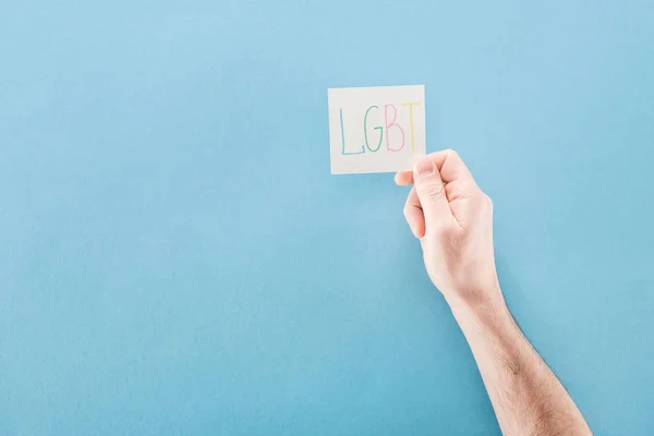 Partial View Man Holding Card Lgbt Handwritten Abbreviation Blue Background — Stock Photo, Image