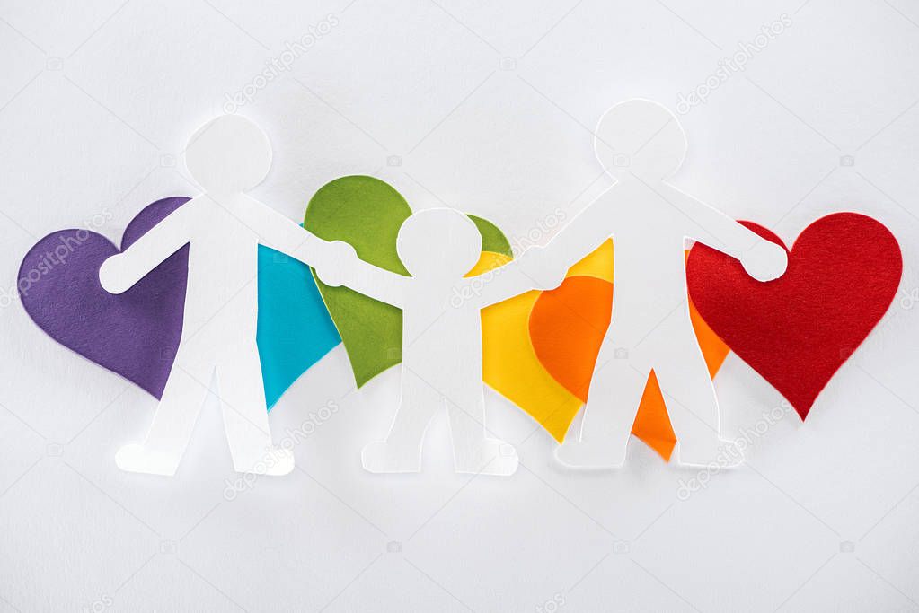 paper cut family and rainbow multicolored paper hearts on grey background, lgbt concept