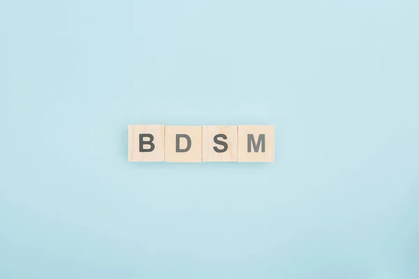 Top View Bdsm Lettering Made Wooden Blocks Blue Background — Stock Photo, Image