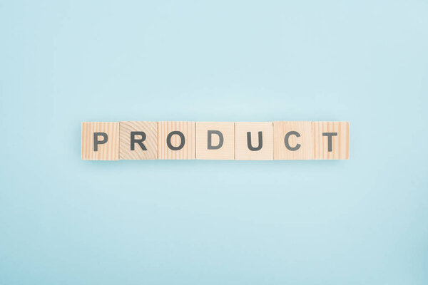 top view of product lettering made of wooden cubes on blue background 