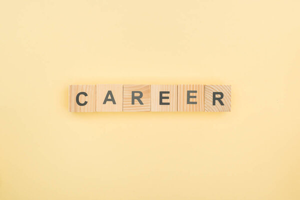 top view of career lettering arranged of wooden blocks on yellow background