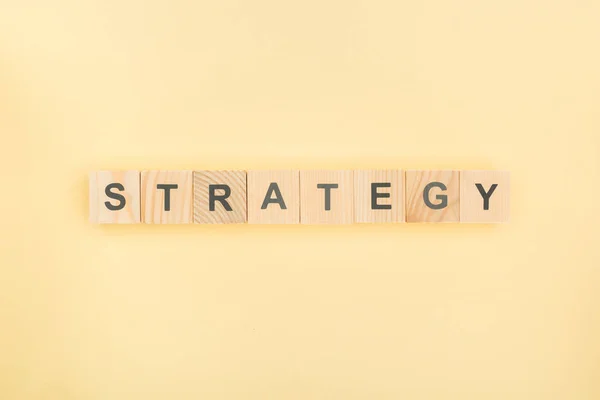 Top View Strategy Lettering Made Wooden Cubes Yellow Background — Stock Photo, Image