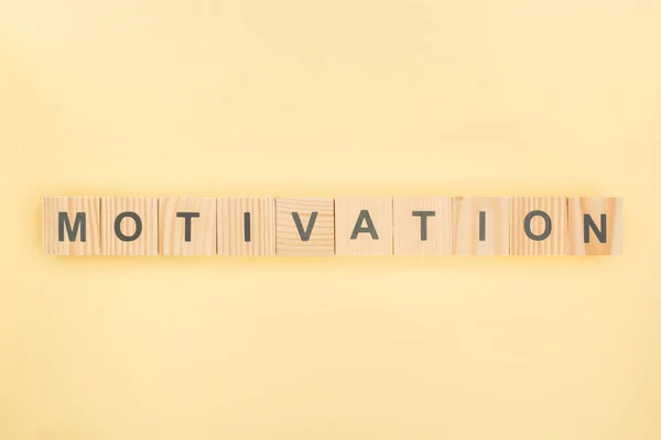 Top View Motivation Lettering Made Wooden Cubes Yellow Background — Stock Photo, Image