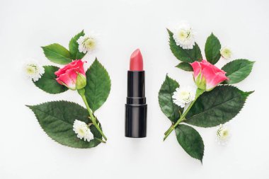 top view of lipstick between boutonnieres isolated on white clipart