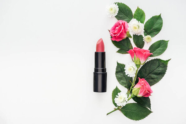 top view of flowers composition with lipstick isolated on white