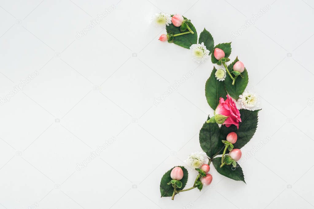 top view of composition with leaves, roses, berries and hrysanthemums isolated on white