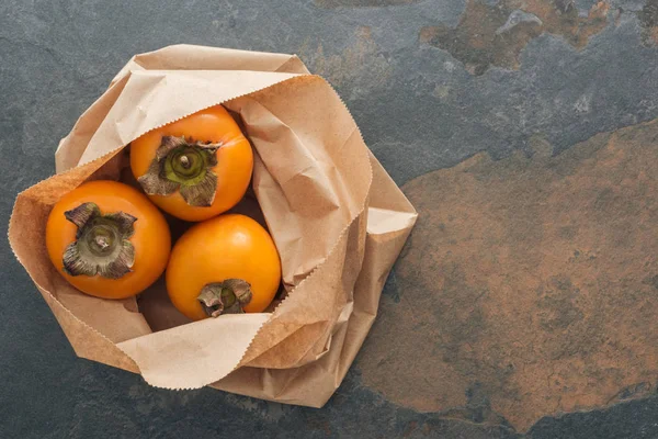 Top View Whole Persimmons Paper Packet Copy Space — Stock Photo, Image