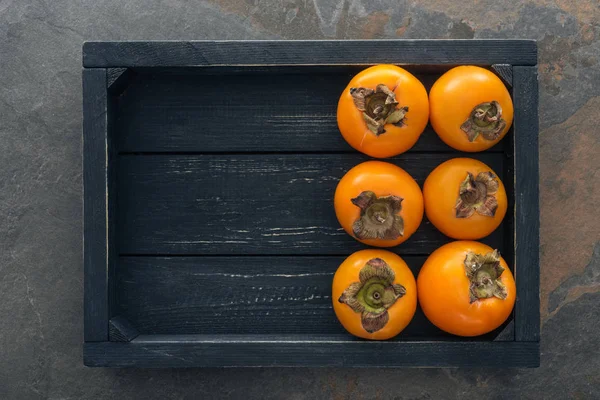 Top View Whole Persimmons Black Box Copy Space — Stock Photo, Image