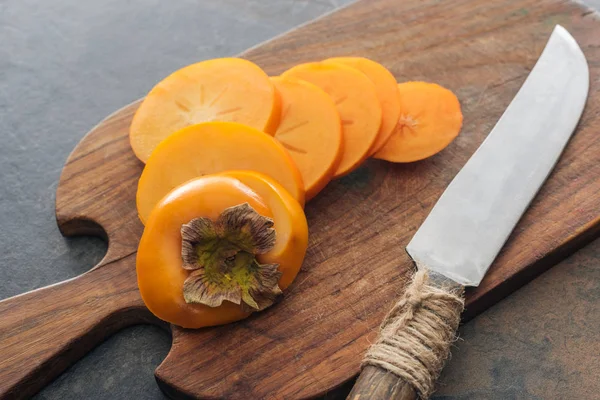 Sulu Lezzetli Persimmons Kesme Tahtası Üzerinde Bıçakla Dilimlenmiş — Stok fotoğraf