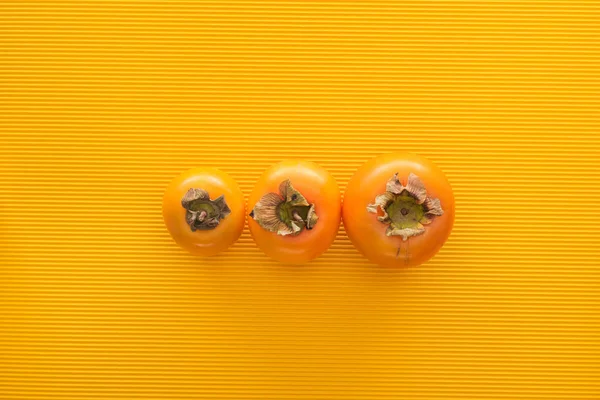 Top View Orange Persimmons Yellow Background Copy Space — Stock Photo, Image