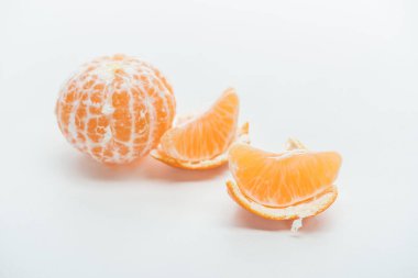 tangerine slices with peel and whole fruit on white background clipart