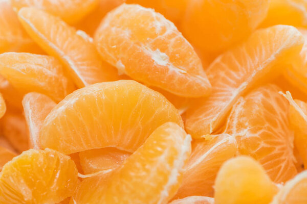 close up of bright orange tangerine peeled slices 