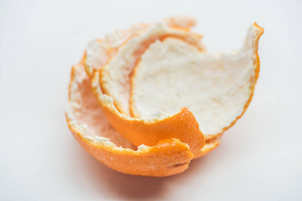 selective focus of tangerine peel on white background