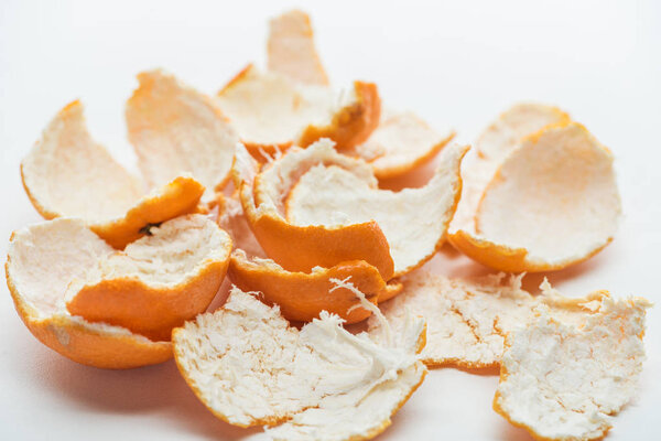 selective focus of tangerines peel on white background