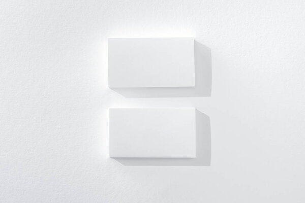 top view of empty cards on white background with copy space