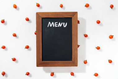 top view of chalk board with menu lettering among cherry tomatoes clipart