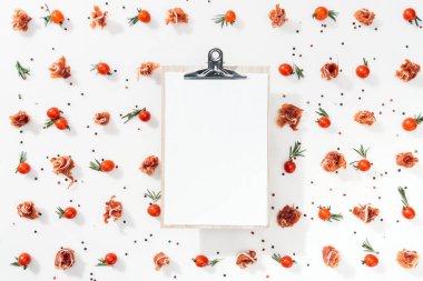 top view of blank clipboard with cherry tomatoes, leaves, spices and prosciutto clipart