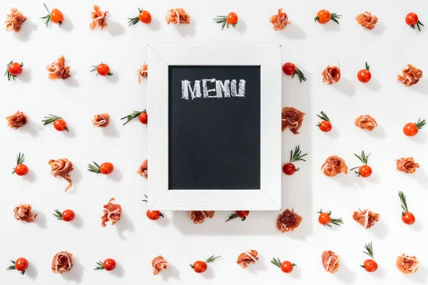 Top view of chalk board with menu lettering among cherry tomatoes, prosciutto, spices and leaves — Stock Image Top View Chalk Board Menu Lettering Cherry Tomatoes Prosciutto Spices Stock Photo