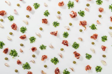 top view of prosciutto, olives, garlic cloves and greenery clipart