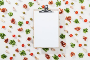 top view of empty clipboard among prosciutto, olives, garlic cloves, greenery and cherry tomatoes clipart