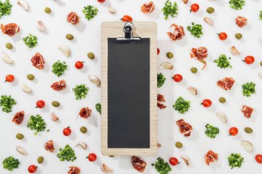empty clipboard among prosciutto, olives, garlic cloves, greenery and cherry tomatoes clipart