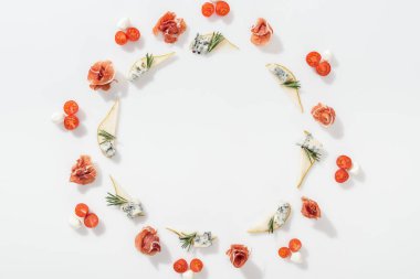 top view of sliced pears with blue cheese and rosemary twigs near tasty prosciutto, cherry tomatoes and mozzarella cheese on white background clipart